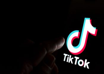 Tiktok,App,Logo,On,Screen,And,A,Finger,Pointing,At